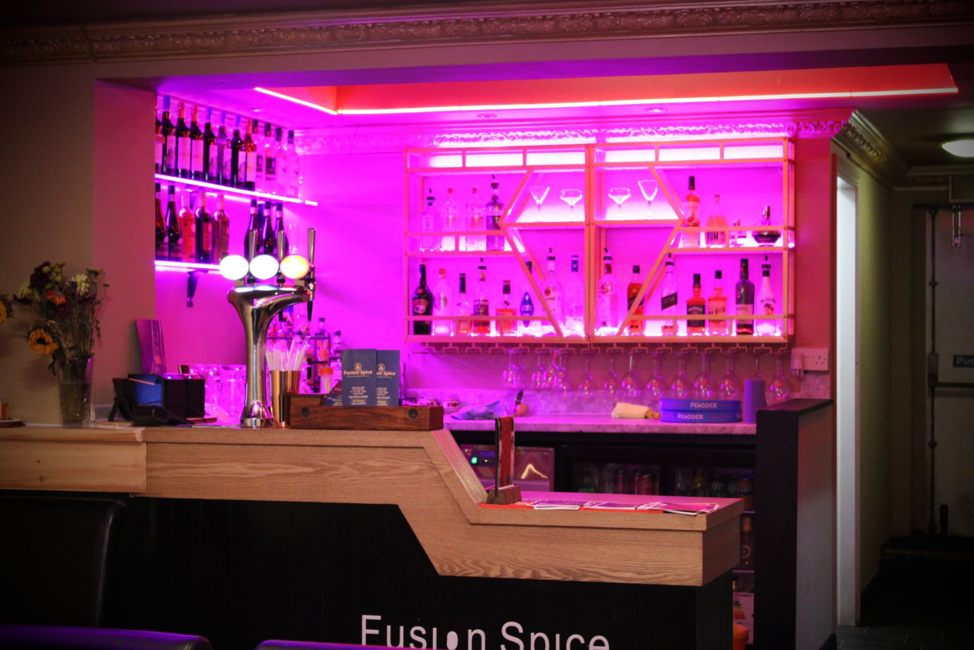Full view of the neon-lit cocktail bar